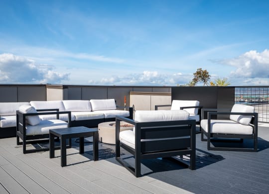 a terrace with couches and tables on a roof
