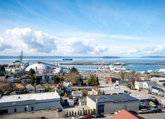 an aerial view of the city with the ocean in the background