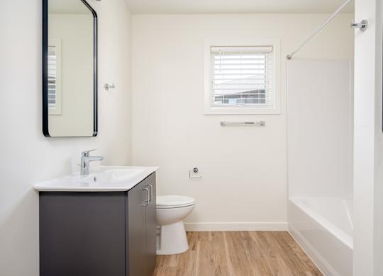 A bathroom with a sink, toilet, and bathtub.