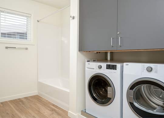A laundry room with a washer and dryer.