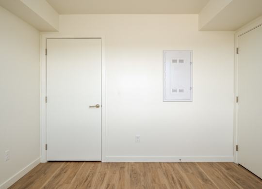 A white door is on the left and a white framed door is on the right.