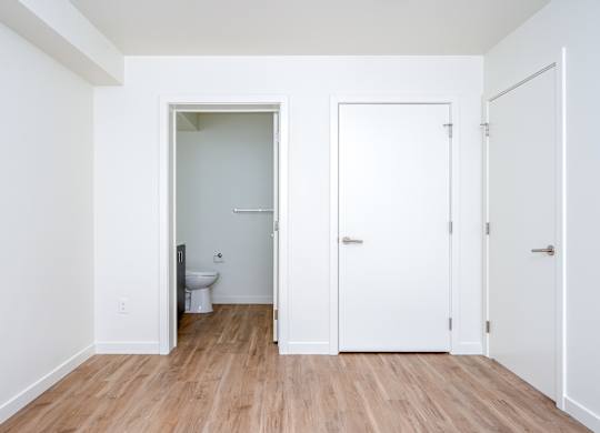 A white bathroom with a toilet and sink.