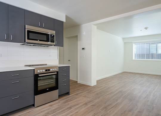 A kitchen with a stove top oven and microwave above it.