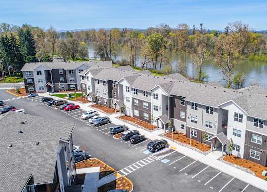A parking lot in front of apartment buildings.