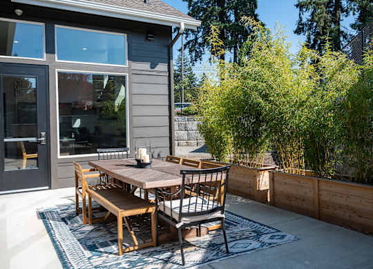 A table with chairs is on a patio.