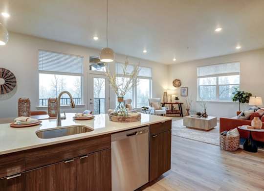 A modern kitchen with wooden cabinets and a large island.