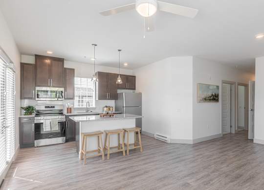 A modern kitchen with a dining table and chairs.