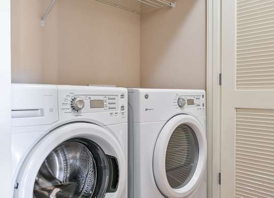 two washers and dryers in a laundry room