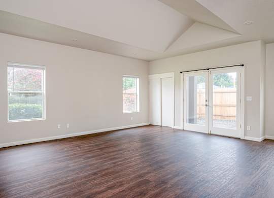 A room with wooden floors and white walls.