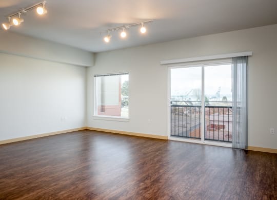 living room with wood flooring and sliding glass doors to balcony