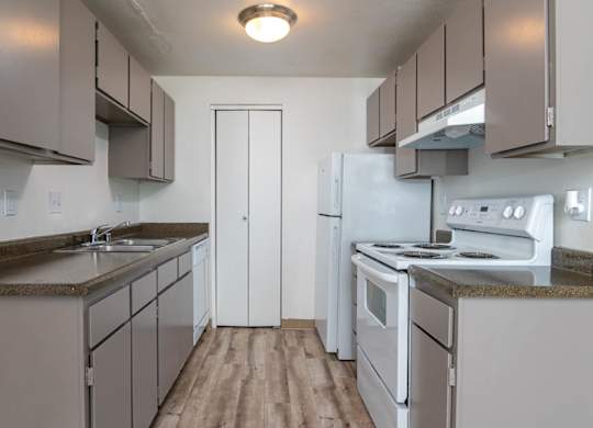 Sedona | One Bedroom Kitchen with plank style flooring and white appliances