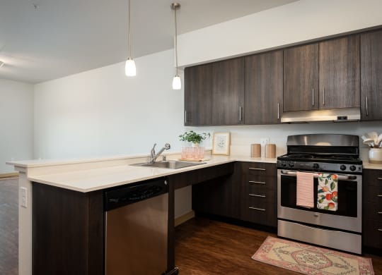 a kitchen with dark wood cabinets and a white counter top