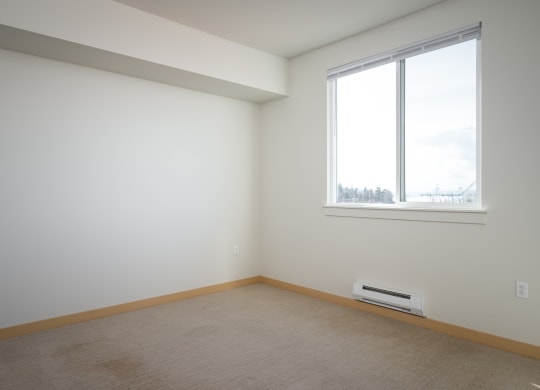 bedroom with large window and carpet