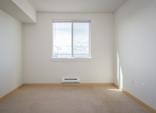 bedroom with a large window and carpet