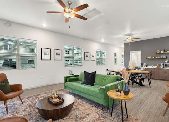 A living room with a green couch and a coffee table.