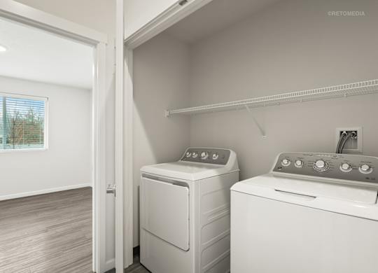 A white dryer and washer are sitting next to each other in a small laundry room.
