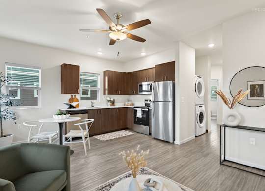 A modern kitchen with a dining table and chairs.