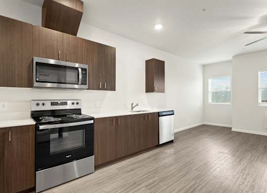 A modern kitchen with wooden cabinets and stainless steel appliances.