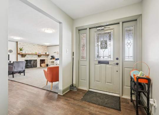 A room with a grey door and a grey couch.