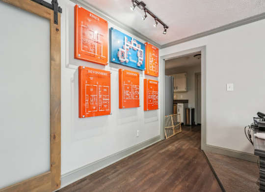 A hallway with orange posters on the wall.