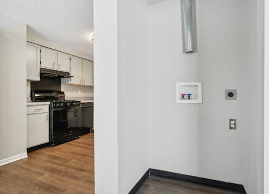 A kitchen with white cabinets and a black stove top oven.