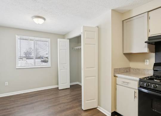 A kitchen with a black stove top oven and a white door.