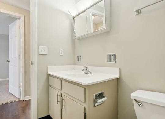 A bathroom with a white sink and a white tub.