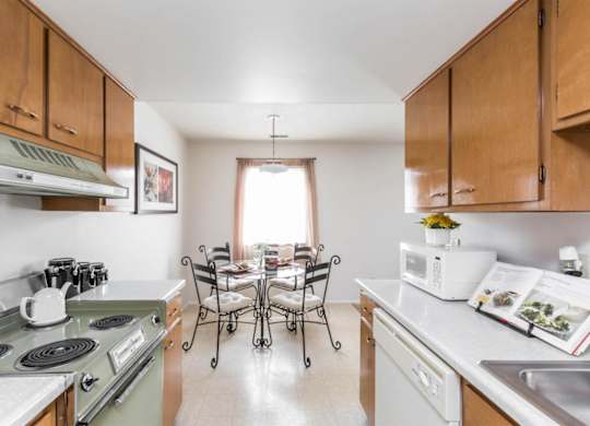 A kitchen with a stove, oven, and sink.