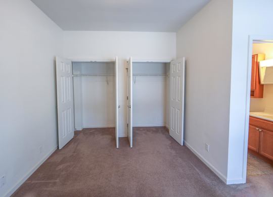 A room with white walls and a brown carpet.