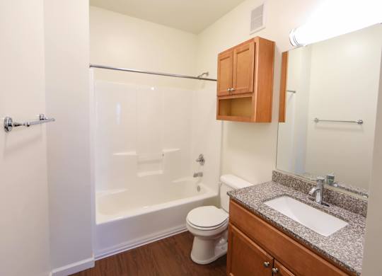 A bathroom with a toilet, sink, and shower.