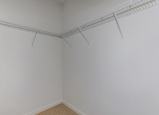 A white wall with a metal rack on it.