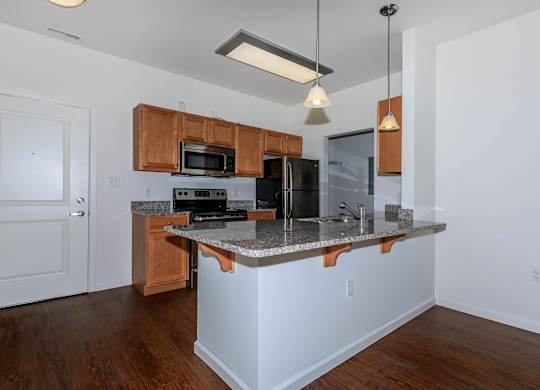 A kitchen with a white island and wooden cabinets.