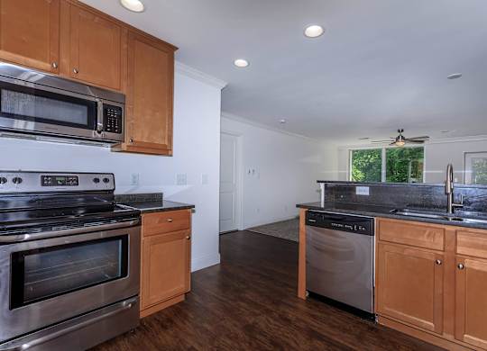 A kitchen with wooden cabinets and stainless steel appliances.