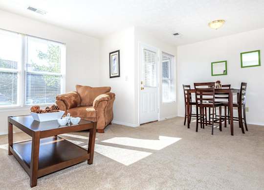 A living room with a brown chair and a coffee table.