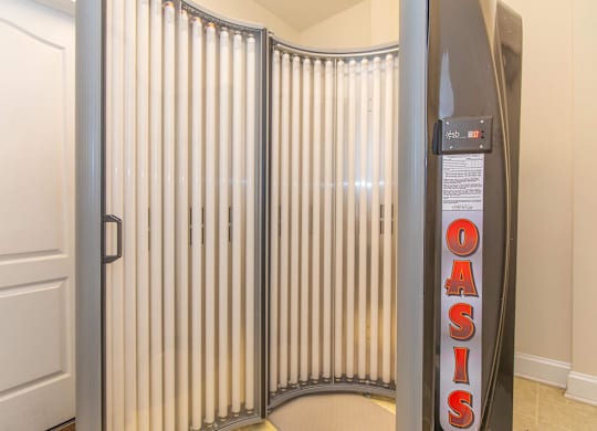 A room with a white door and a wall with a sign that says Oasis.
