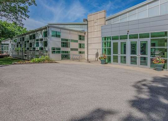 A building with a glass facade and a large courtyard.