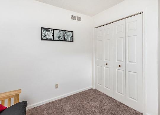 A white door with a brown carpet in front of it.