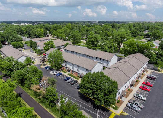 A parking lot with cars and a building in the background.