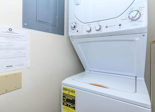 A white washing machine with a yellow sticker on the door.