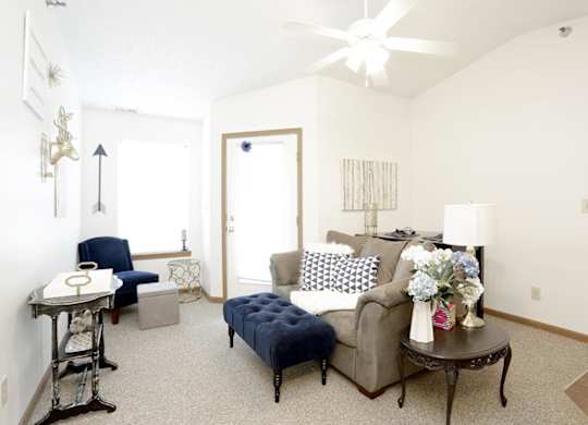 A living room with a blue couch and a coffee table.