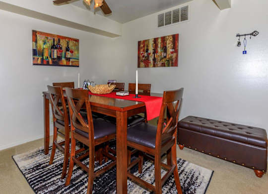 A dining room with a wooden table and chairs.