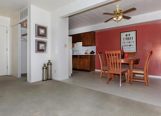 A living room with a dining table and chairs.
