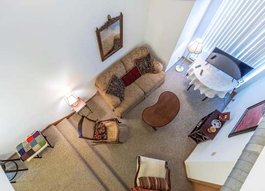 A living room with a couch, chair, and a rug.