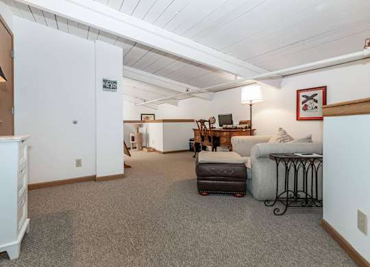 A living room with a couch, chair, and a table.