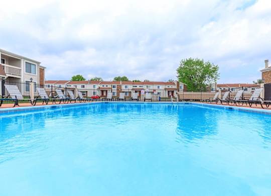 A large swimming pool with a blue tinted water.