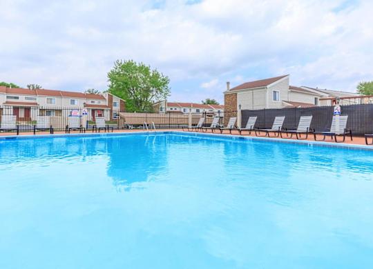 A large blue swimming pool in a residential area.
