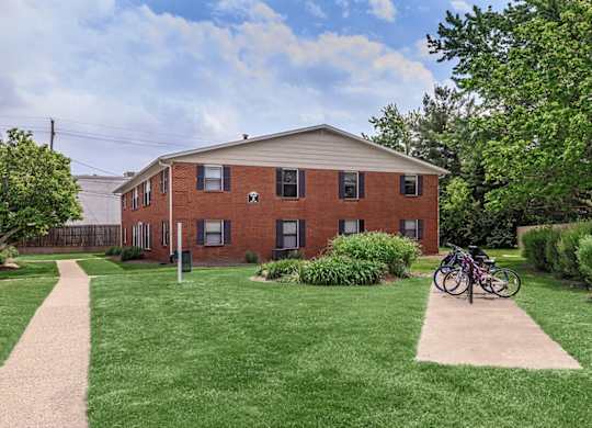 A red brick building with a bicycle parked in front.