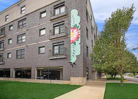 A large building with a large flower painted on the side.