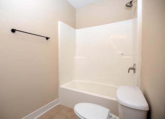 A white toilet and sink in a small bathroom.