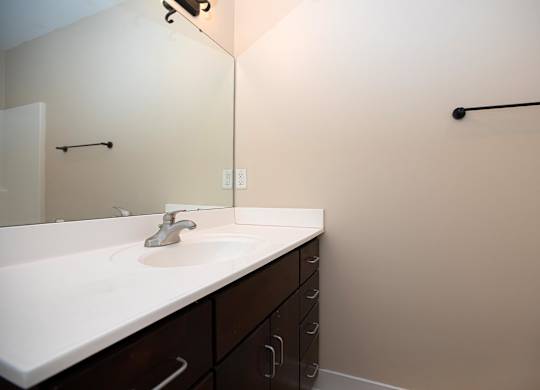 A bathroom with a sink and a mirror.